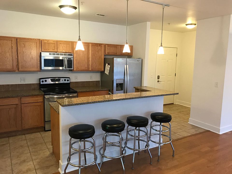 Open Modern kitchen _ granite countertops & hardwood floors = sleek & easy to clean