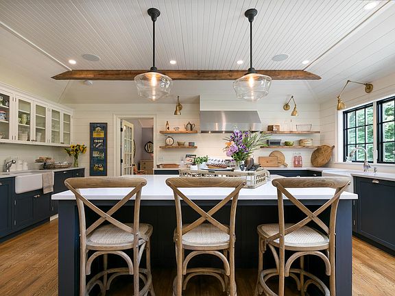 HUGE chef's kitchen is an entertainer's DREAM! This kitchen features a 48" professional-grade Viking 6-burner stove with stove, 2 ovens, a Sub-Zero fridge, 2 Bosch dishwashers, 2 porcelain farmhouse sinks and 4 under-counter garbage and recycling bins.