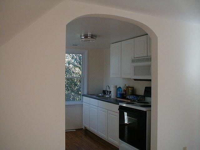 Kitchen-view from living room, refrigerator is across from stove