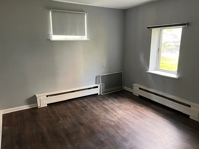 Unfurnished basement bedroom with abundant natural light and flexible layout potential.