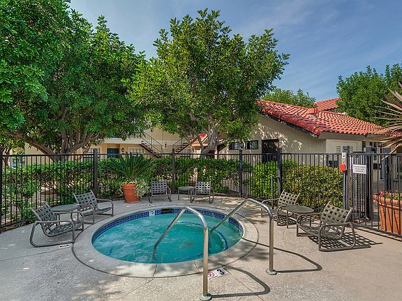 Spa surrounded by lounge chairs.