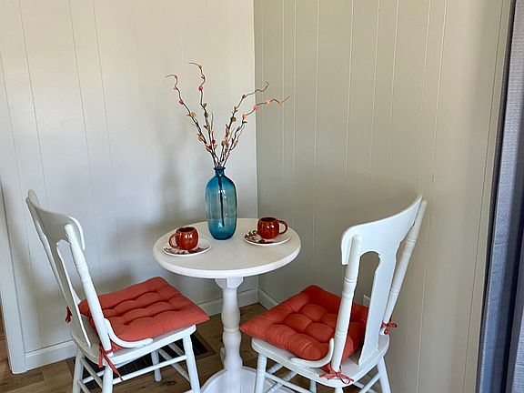 Dining area located within living area. Furniture included or can be removed if not needed. Decor not included. Notice new flooring and fresh paint!