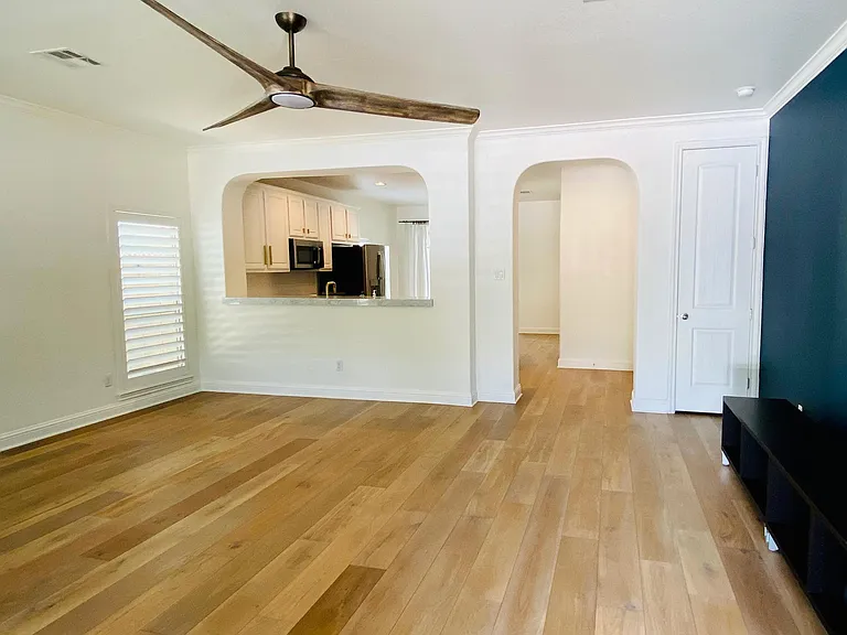 Entrance view into living room with top of the line hardwood flooring; open concept floor plan.