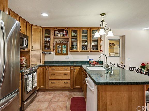 Kitchen has been remodeled with new birch cabinets, stone counter and built in stainless steel appli