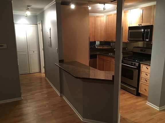 hallway to bathroom with extra closet at end