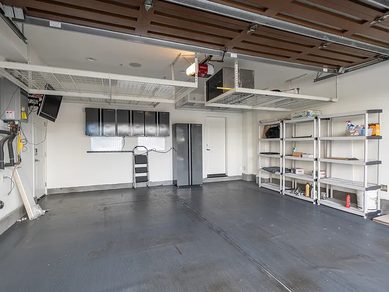 2-car garage with EV charging and overhead storage shelves