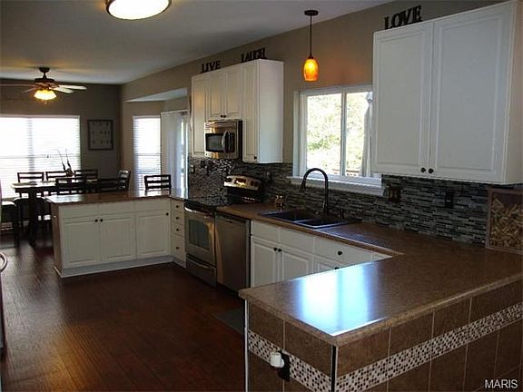 Lots of cabinets and counter space. Extra windows let in the light.