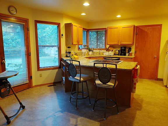 Open kitchen with granite counter tops, and dishwasher