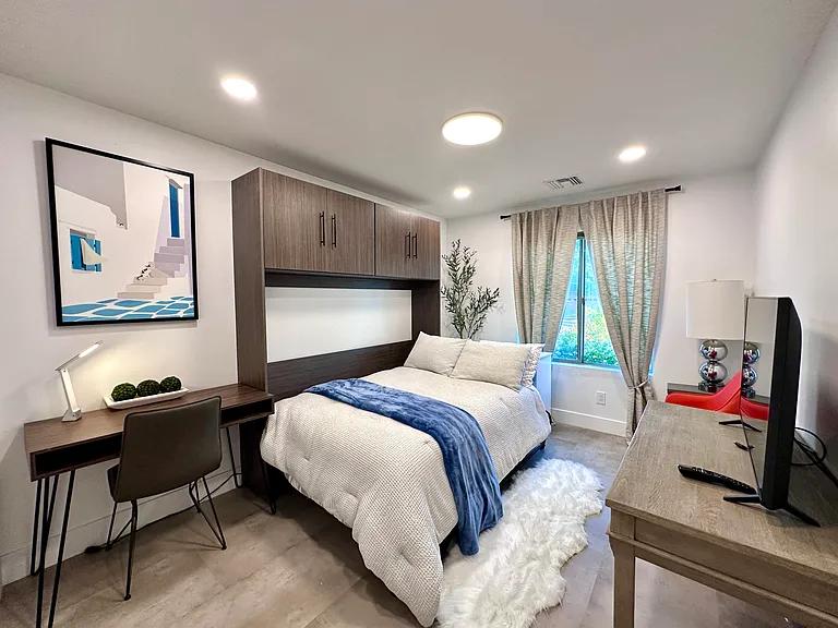 Guest Bedroom 2: 
Versatile Full-size Murphy bed with a working desk , TV set and sitting corner , perfect for maximizing living space during the day.