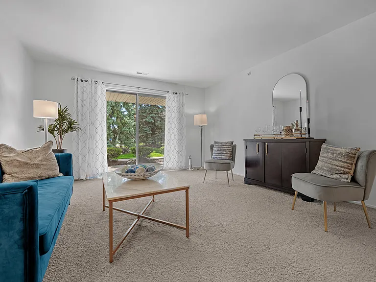 Spacious Living room with patio at Prentiss Pointe Apartments in Harrison Township