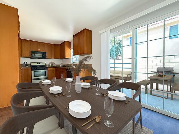 Modern kitchen with access to large backyard.