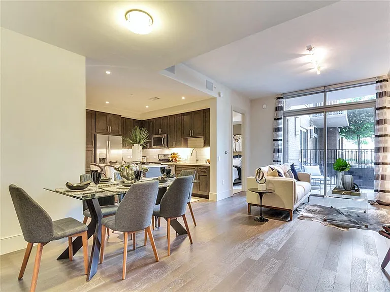 Hardwood floor throughout the living room, dining room and kitchen