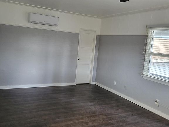 Main living space, includes ceiling fan, window view.