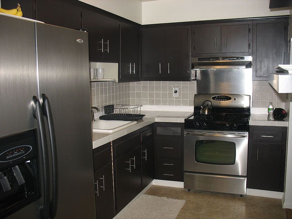 Contemporary Stainless Steel Kitchen w/ Wooden Chocolate Painted Cabinets