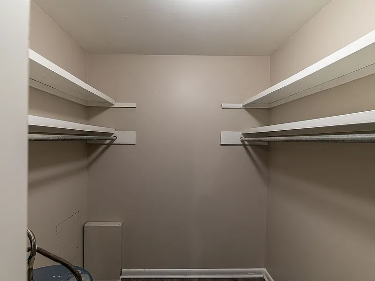 Maximize your organization with this expansive walk-in closet, complete with extensive shelving.