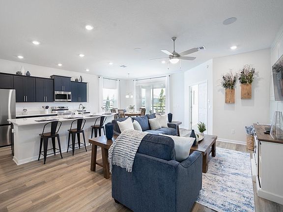 This home includes a sunny and spacious open-concept living area - Shelby II by Highland Homes