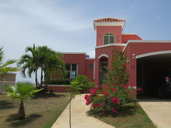 Entrance showing attached open garage
