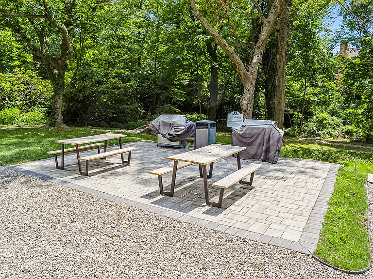 Enjoy a scenic BBQ gathering in this serene garden spot, perfect for outdoor dining.
