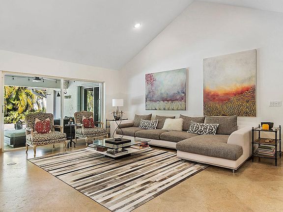 Great room with vaulted ceiling open to patio.