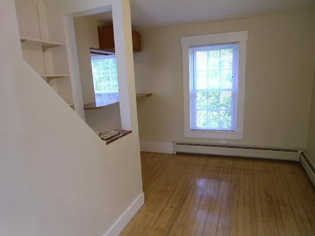 Room behind Kitchen looking toward pass-through to Kitchen.