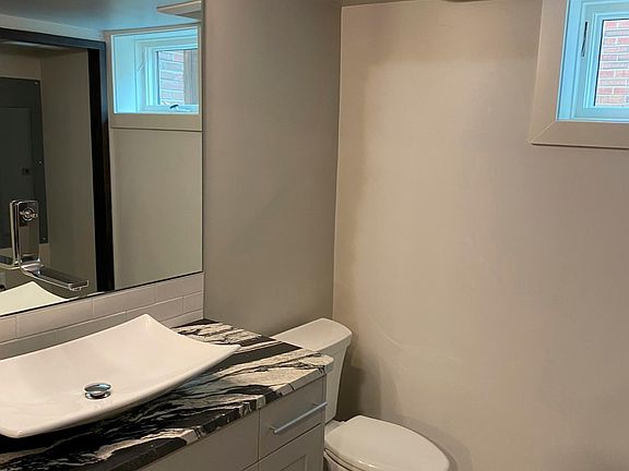 Half Bath With Stacked Washer and Dryer