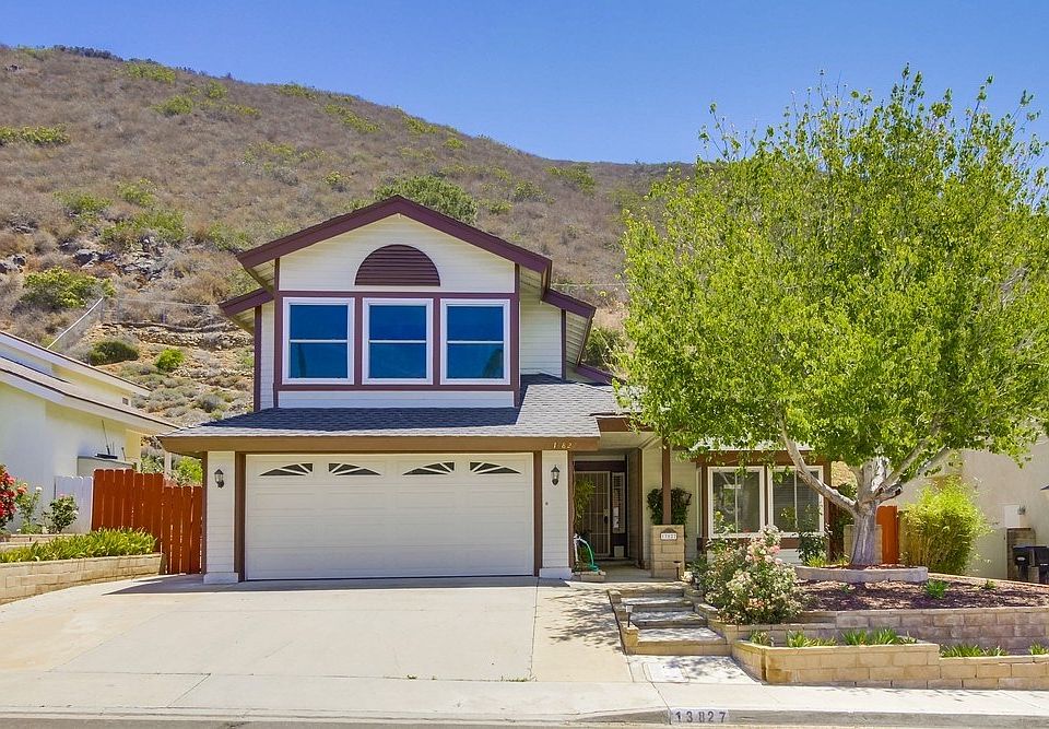 Sitting area in front yard near tree.