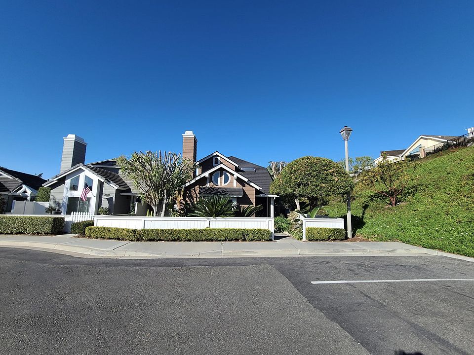 WELCOME TO 18 CARRACK! A home surrounded in gardens at the edge of the greenbelt hillside with cul-de-sac and guest parking both front and back