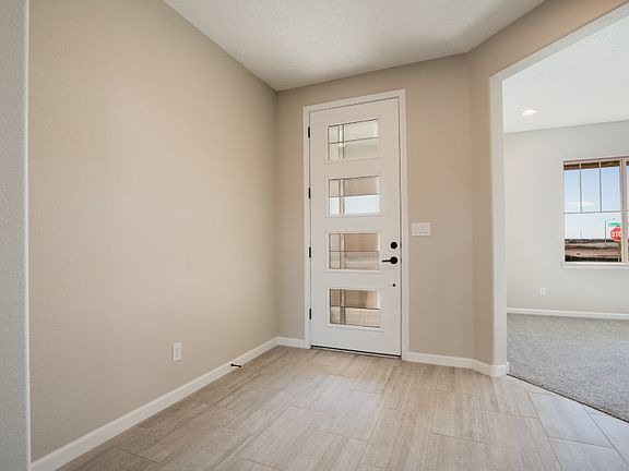 The entryway of the Trento opens to a spacious den.