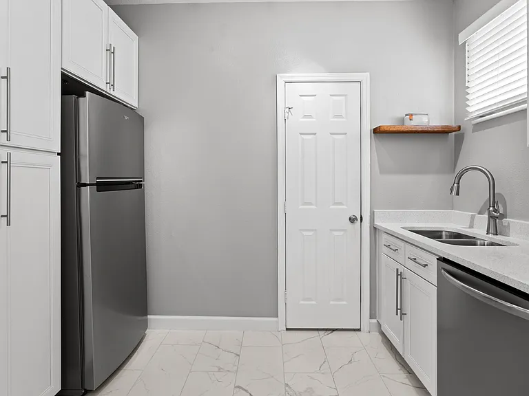 Kitchen with white cabinets and stainless steel appliances