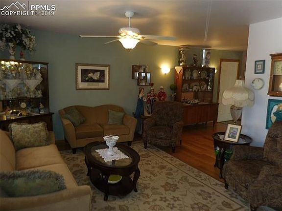 Upon entry into the home, you are greeted by the lovely living room with the beautiful oak hardwood floor and the cherrywood inserts