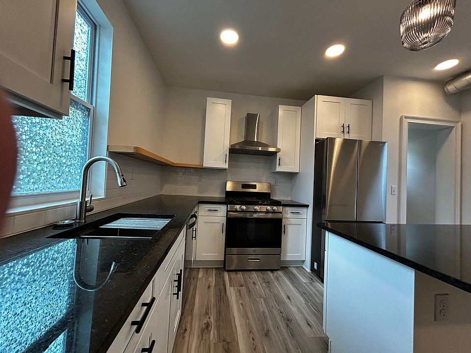 Kitchen with Breakfast Bar, Granite Tops and Floating Shelf