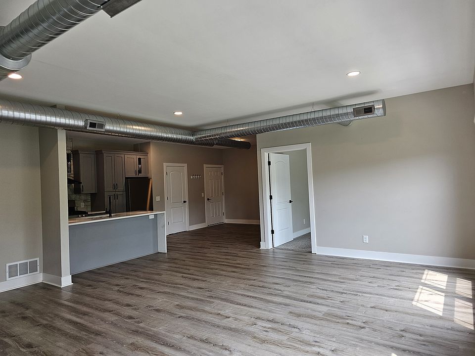 View of kitchen and entry from living room