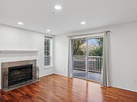 Open-concept living with designer flooring and recessed lighting.