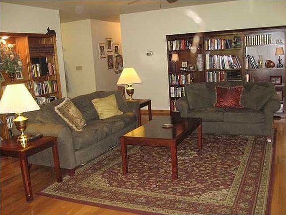 Charming living room with built-in bookcases and masonry fireplace.