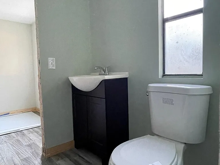 Shared guest bathroom with new vanities, lighting, new toilet and brand new deep soak tub with new shower surround.