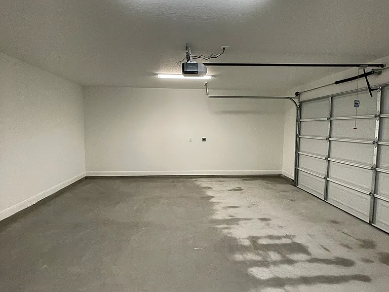 Garage now has Rubbermaid Fasttrack rails on wall for storage, as well as an EV charger.