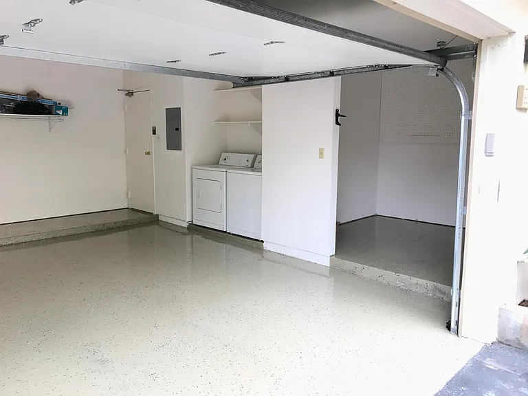 Two car garage with water heater, washer, dryer and big storage space