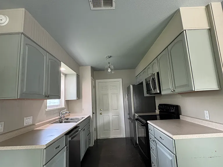 Kitchen with dishwasher, stove, microwave and fridge