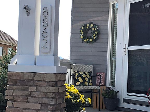 Covered front porch with glass and retracting screen storm door.
