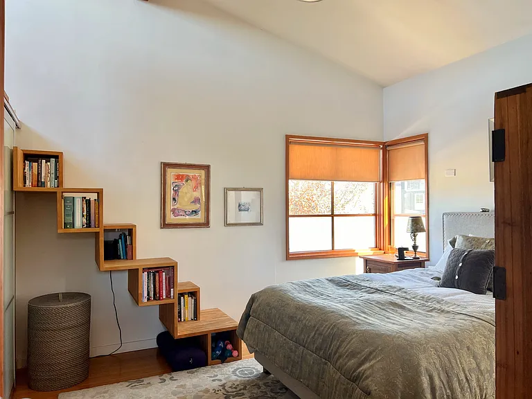 Primary Bedroom with bookcase stair to Loft