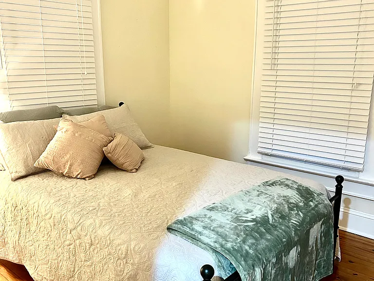 Guest bedroom with double closet and full size bed
