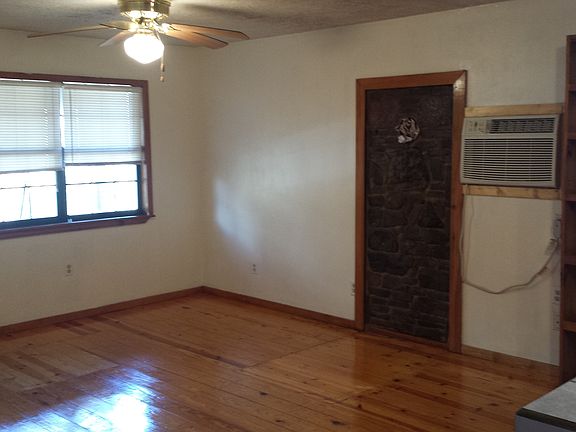 living room with wall a/c as