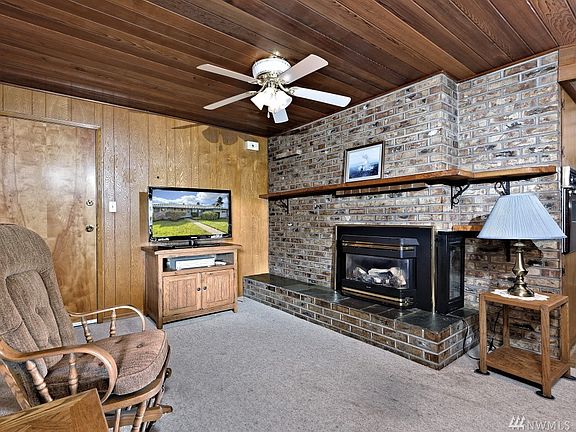 The second family room - both the living room and the family room have separate natural gas inserts that run off of thermostats to keep the temperature just right all year round! The door leads out to the garage,