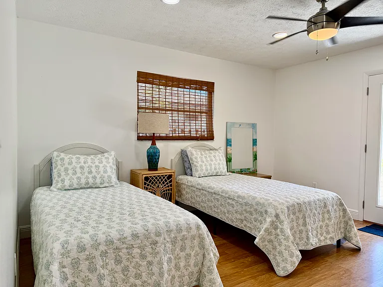 Second bedroom 2 twin beds with doors to outdoor patio.