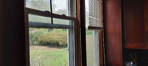 Kitchen windows and original built-in storage cabinet on the north wall of the house. Kitchen is in the north east corner of the first floor.