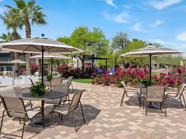 Indulge in the luxury of al fresco dining on our sun deck, featuring umbrella-covered tables and chairs for your exquisite dining experience.