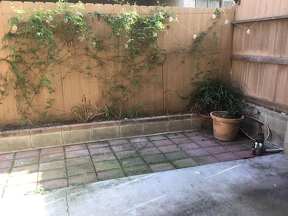 Patio is fully fenced and bricked and has small planting area.