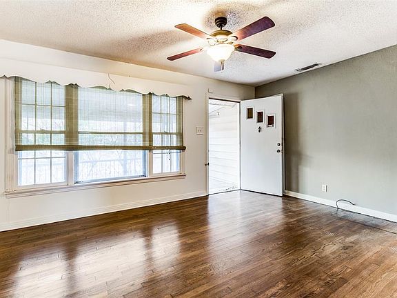 Step into Large Living Room with Original Gleaming Hardwoods