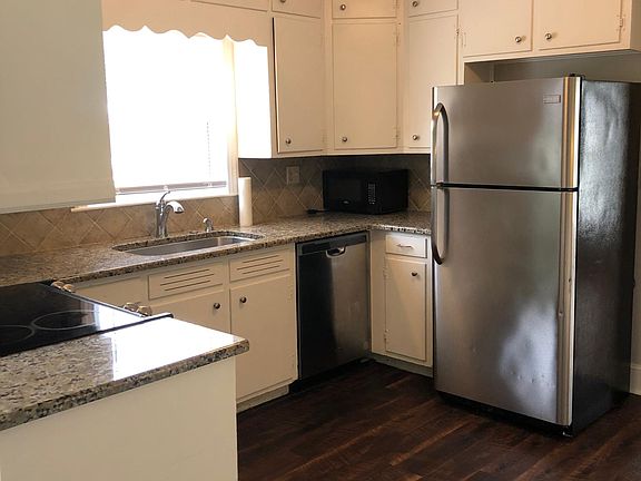 Kitchen (breakfast area not shown). Granite countertops, stainless range, refrigerator, dishwasher, large single bowl sink with disposal.