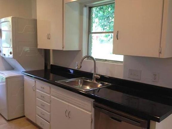 Large Kitchen with washer-dryer, dishwasher, fridge, and stainless sink
